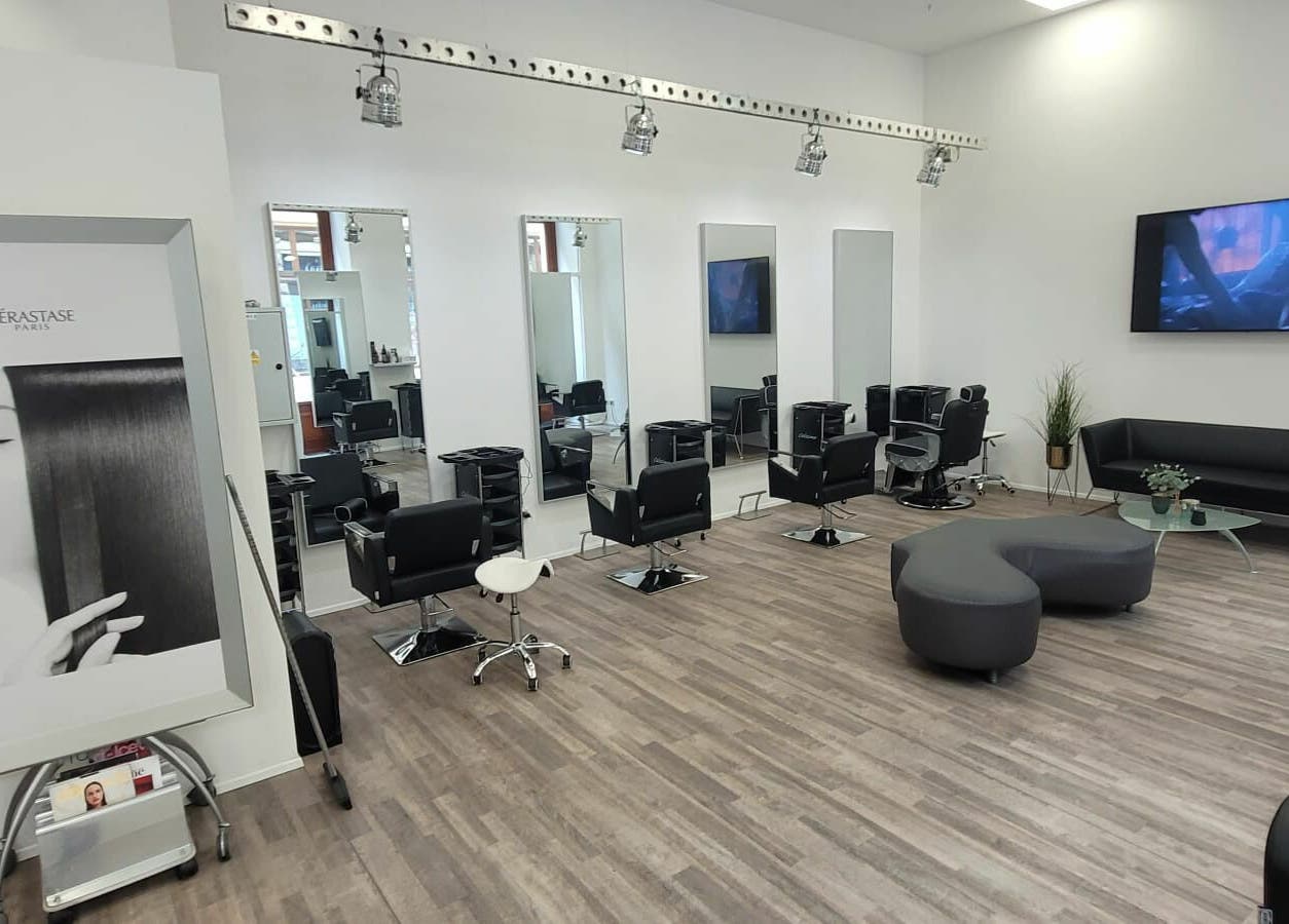 Interior of Hairspace PRG in Hlavní Město Praha, CZ showcasing sleek salon chairs and mirrors.