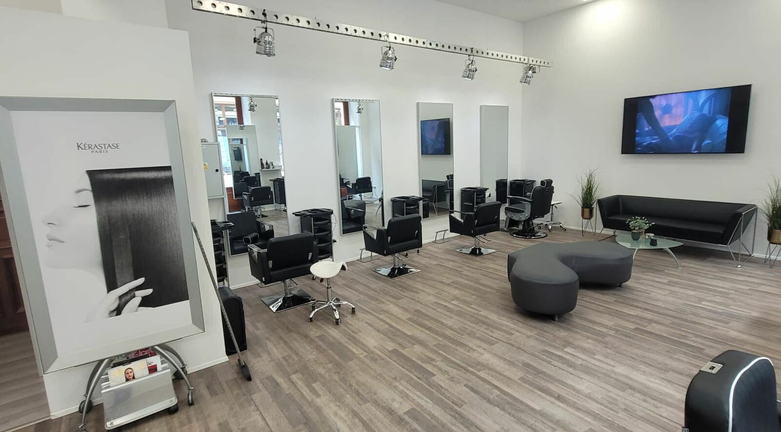 Interior of Hairspace PRG in Hlavní Město Praha, CZ showcasing sleek salon chairs and mirrors.