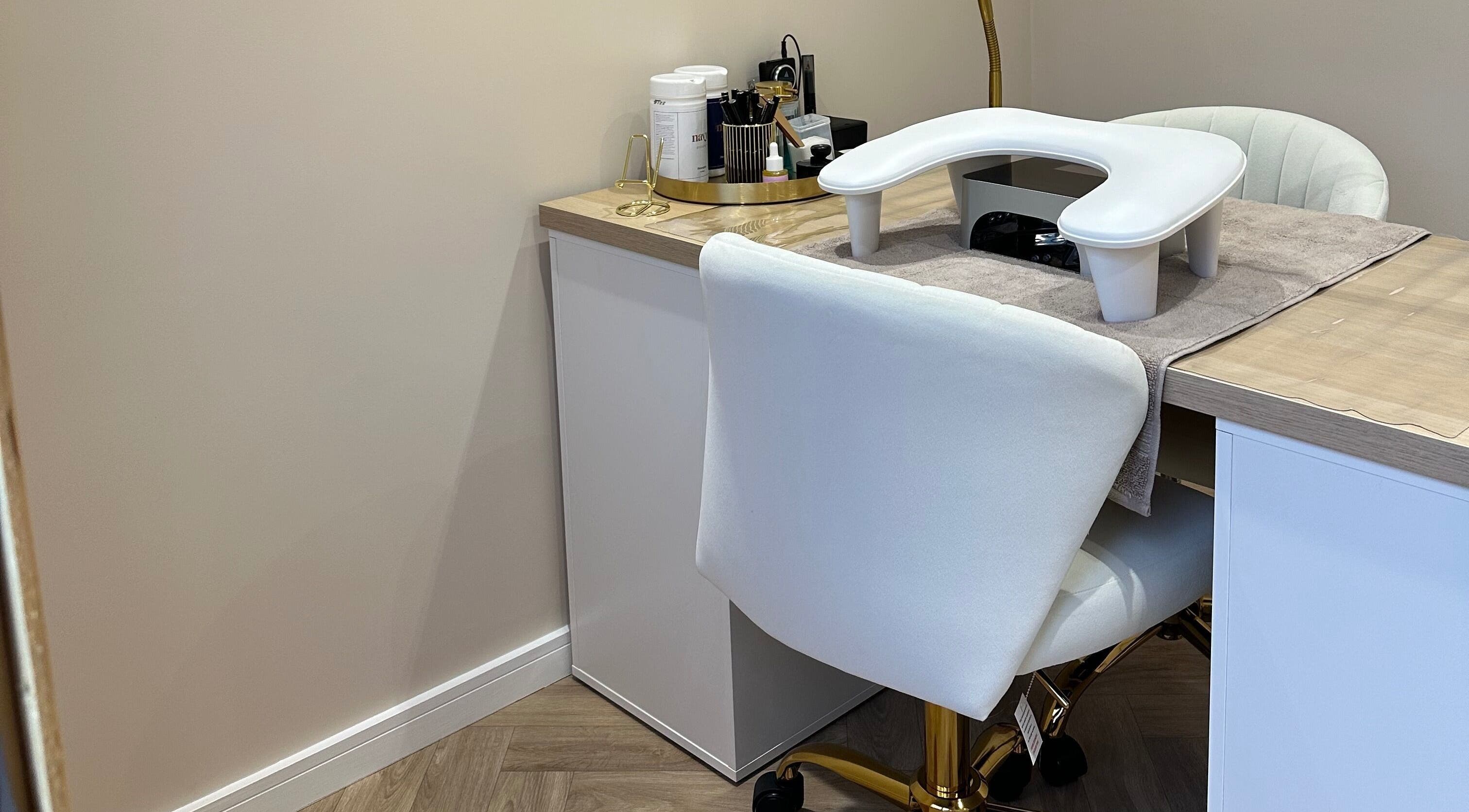 Chic nail service setup at HB Beauty Bar, Houghton Regis, England, GB. Features plush chairs and manicure tools.