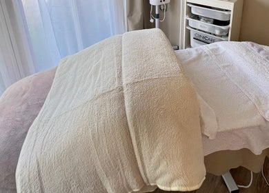 Relaxing treatment bed at Serene Skin Solutions, Carluke, Scotland, GB, ready for a soothing session.