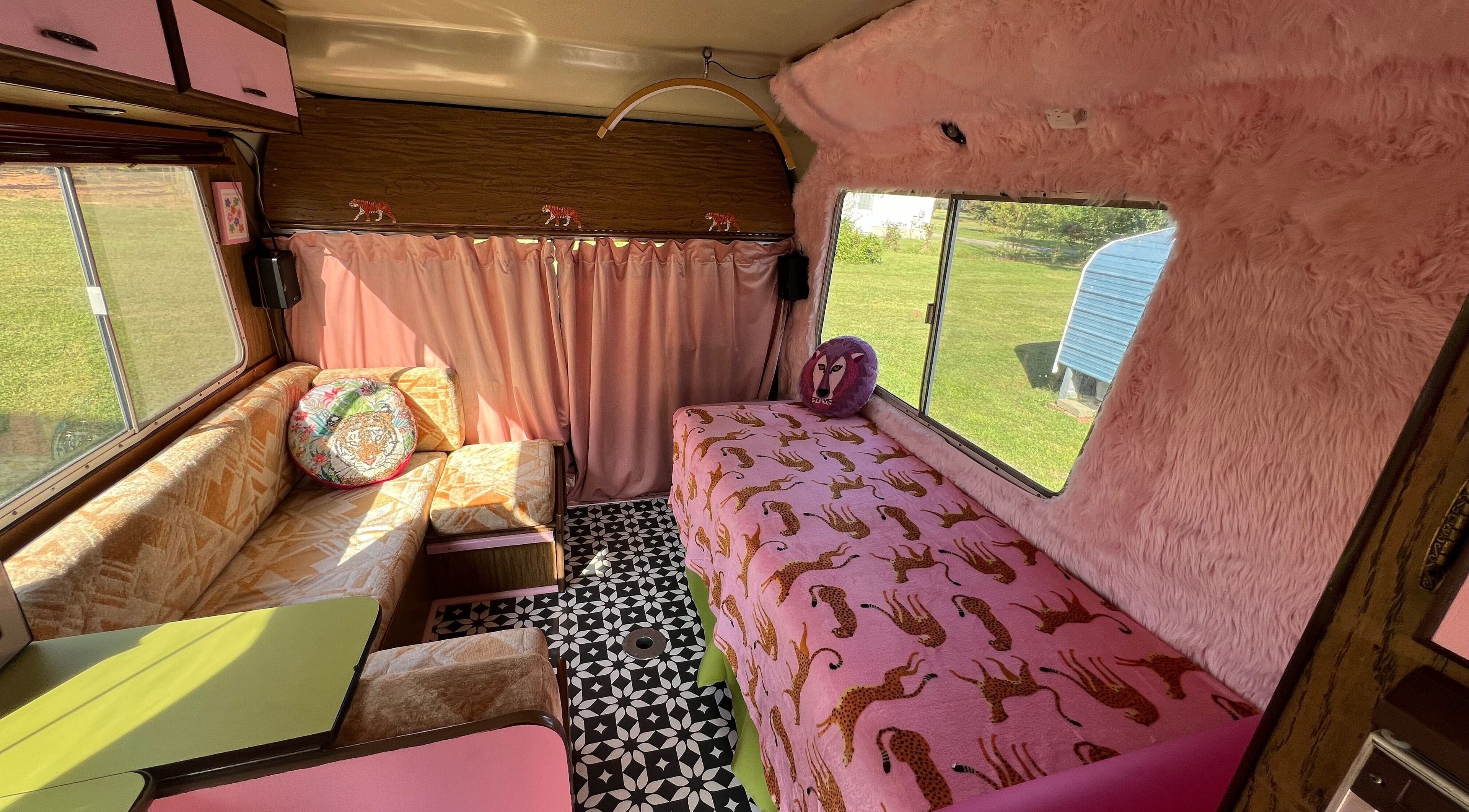 Chic interior of MollyPosh Beauty Bus in Virginia Beach, Virginia, with pink decor and cozy seating.
