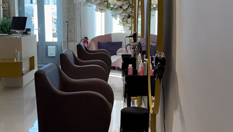 Interior do Albacoa Salon em Viana Do Castelo, PT, com elegantes cadeiras e decoração floral.
