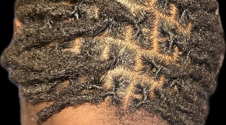 Close-up of intricate locs hairstyle at The Loc Station, Bathgate, Scotland, GB, showcasing expert styling.