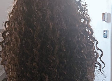 Beautiful curly hairstyle showcased at The Loc Station in Bathgate, Scotland, GB.