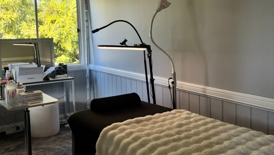 Cozy treatment room at Enchanted Beautique, Coopers Plains, Queensland, AU with plush bed and soft lighting.