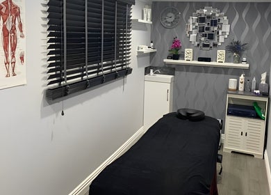 Peaceful massage room at J.F Muscle Medic, Stourbridge, England, GB with modern decor and treatment table.