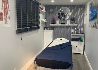 Relaxing treatment room at J.F Muscle Medic, Stourbridge, England, GB with a massage table and calm decor.