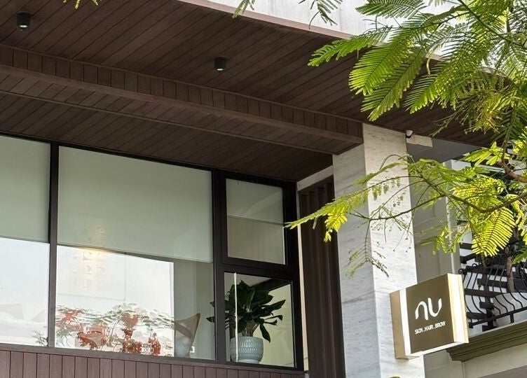 Nu Clinic's modern facade in Hà Nội, VN, adorned with lush greenery and sleek design.