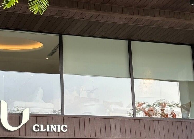 Glass facade of Nu Clinic in Hà Nội, VN, showcasing modern design and serene ambiance.