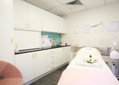 Beauty Circle's tranquil treatment room in Sydney, New South Wales, AU features a cozy bed and calming decor.