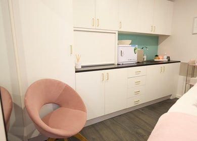 Beauty Circle spa room with modern decor in Sydney, New South Wales, AU, featuring a plush pink chair.