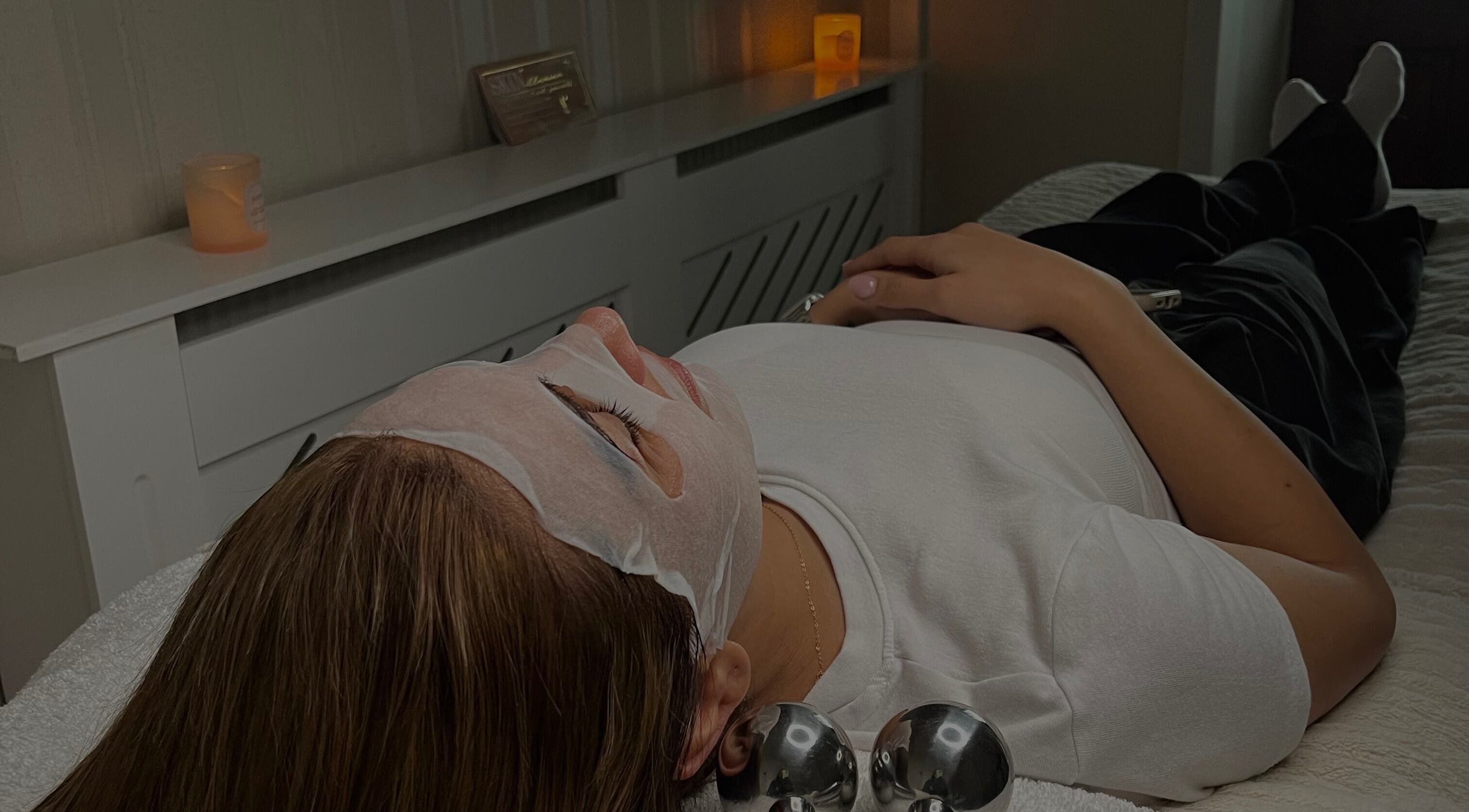 Relaxing facial at Skin By Abbey Charlie, Salford, England, GB. Woman enjoying skincare mask treatment.