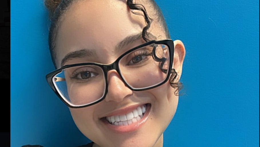 Smiling person with glasses at Key Touch, Woodbridge Township, New Jersey, US.