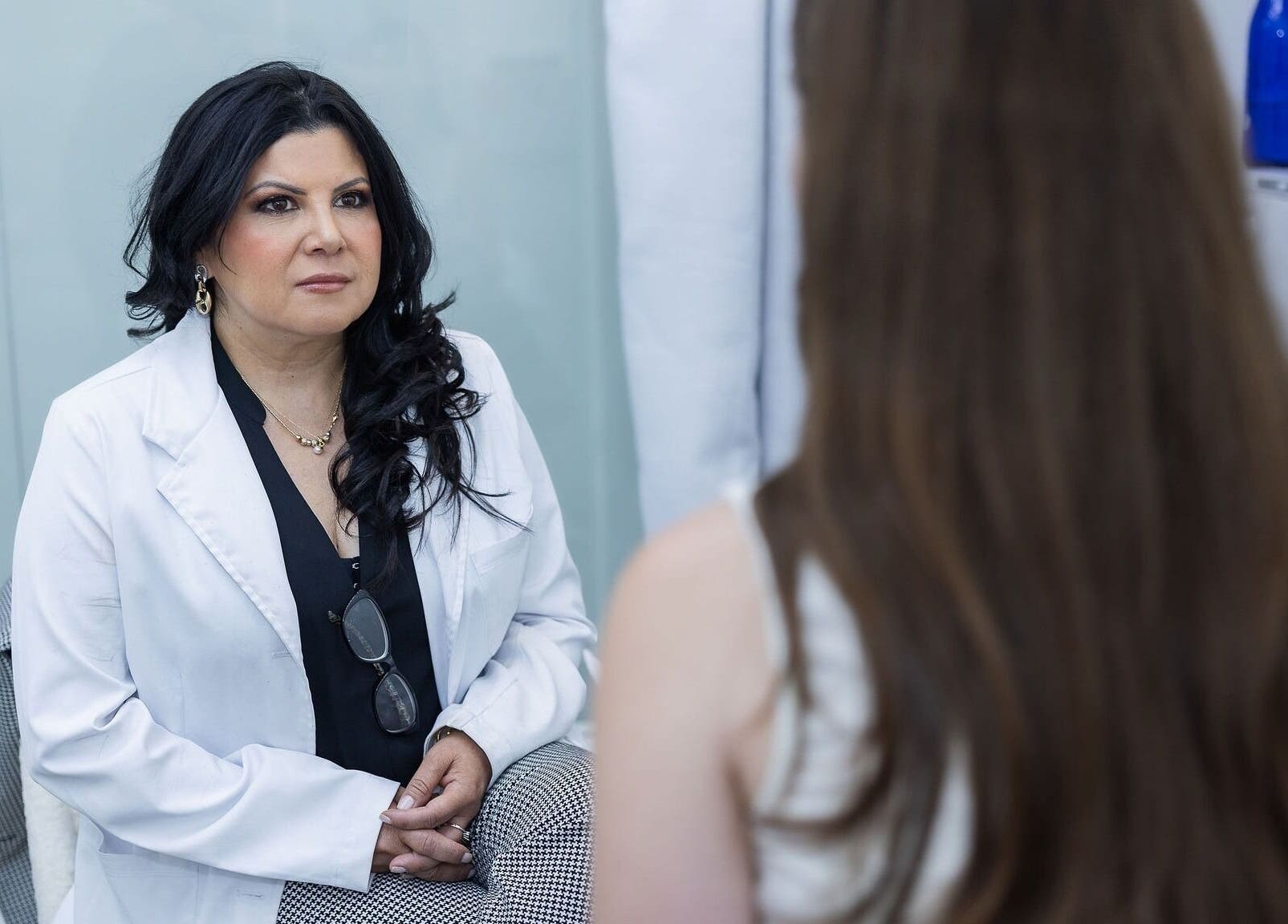 Consultation at Kate Cosmedici Spa - Rockville, Maryland, US. A professional in a white coat discusses with a client.