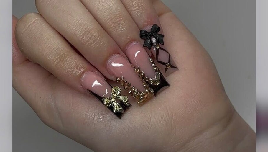 Stylish nail art with gold and black bows at Nailsbyshyy, Oshawa, Ontario, CA.