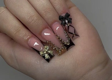 Stylish nail art with gold and black bows at Nailsbyshyy, Oshawa, Ontario, CA.