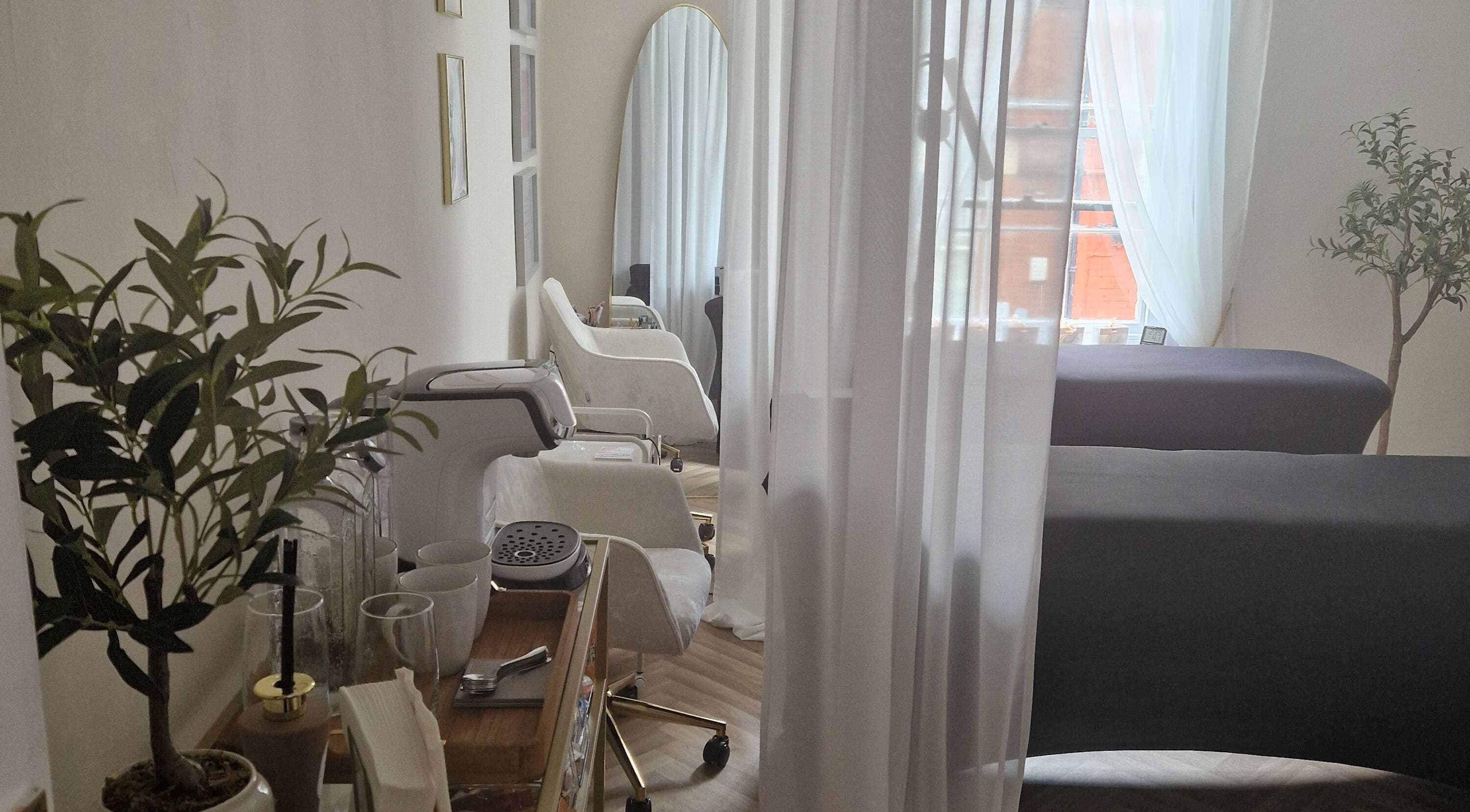 Relaxing interior of Glow365 Beauty Room in Rochester, Kent, GB with elegant seating and natural light.