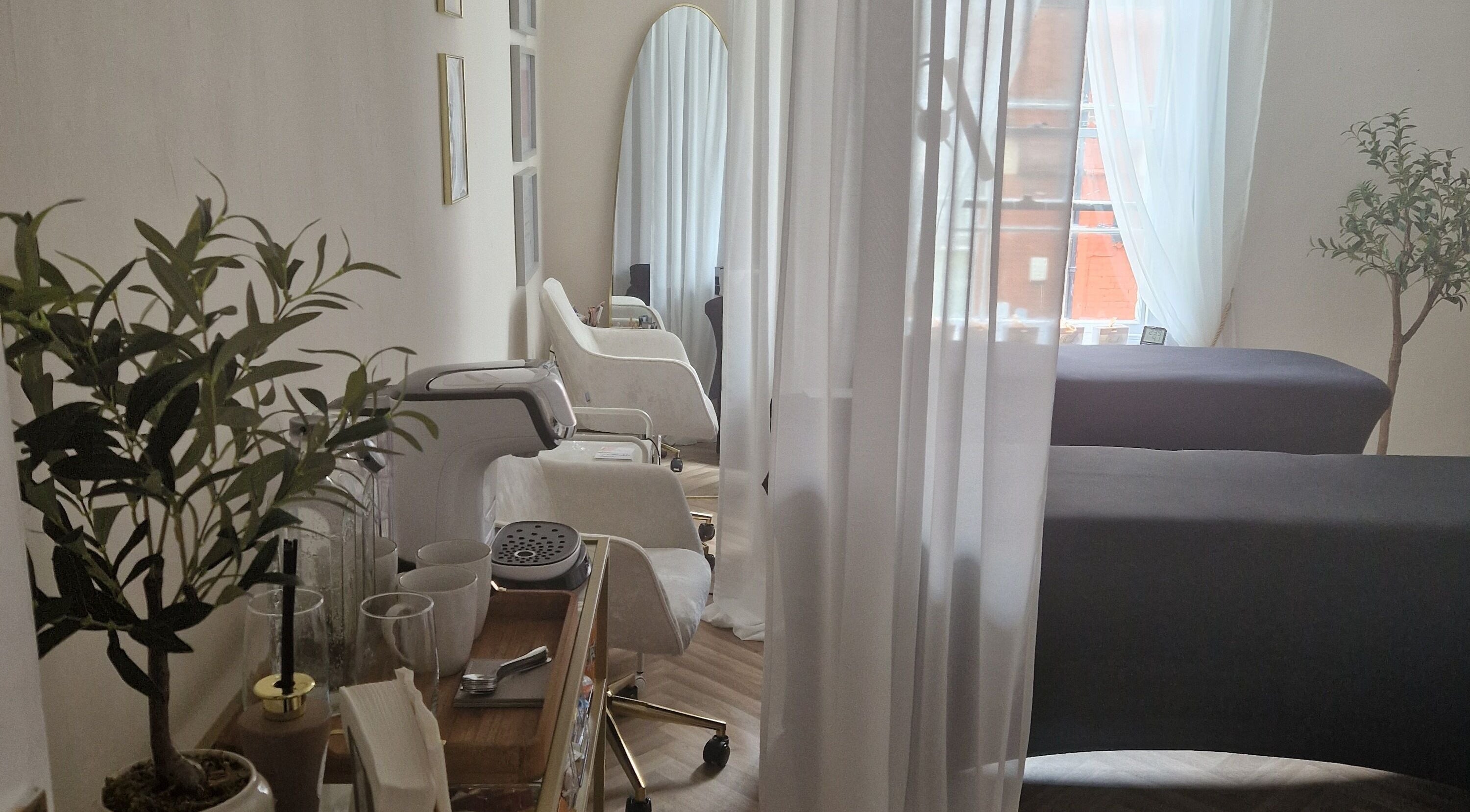 Relaxing interior of Glow365 Beauty Room in Rochester, Kent, GB with elegant seating and natural light.