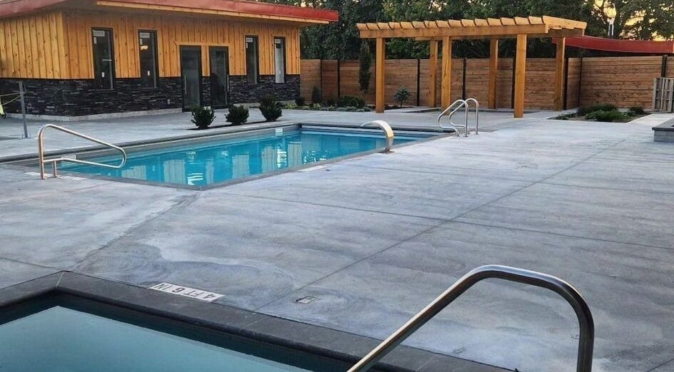 Modern outdoor pool setting at Wave Nordic Spa, Mount Elgin, Ontario, CA with wooden elements and clear water.