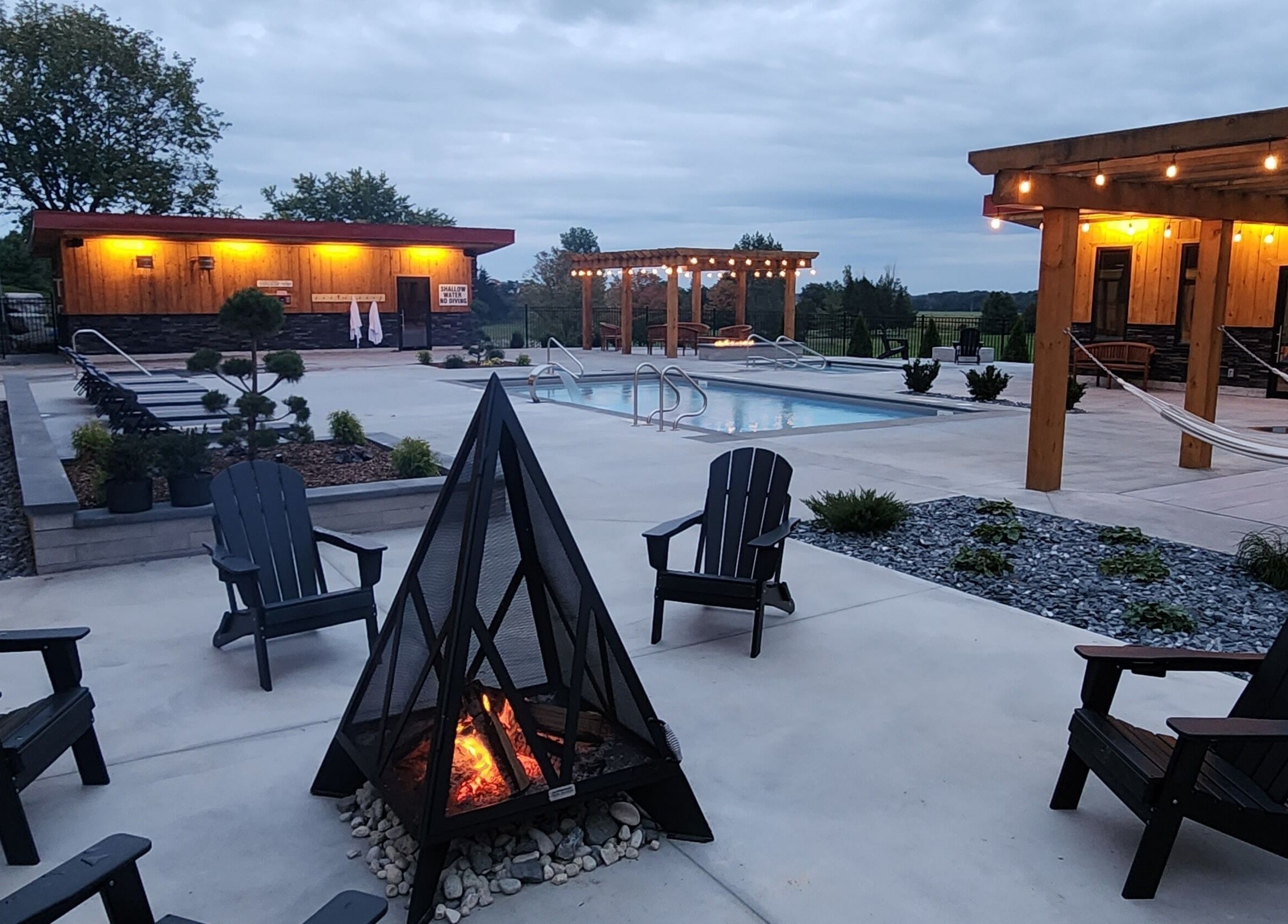 Relax by the fire at Wave Nordic Spa's scenic pool area in Mount Elgin, Ontario, CA. Perfect for a tranquil retreat.