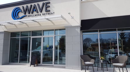 Entrance of Wave Wellness Retreat and Spa in Tillsonburg, Ontario, CA with seating area outside.