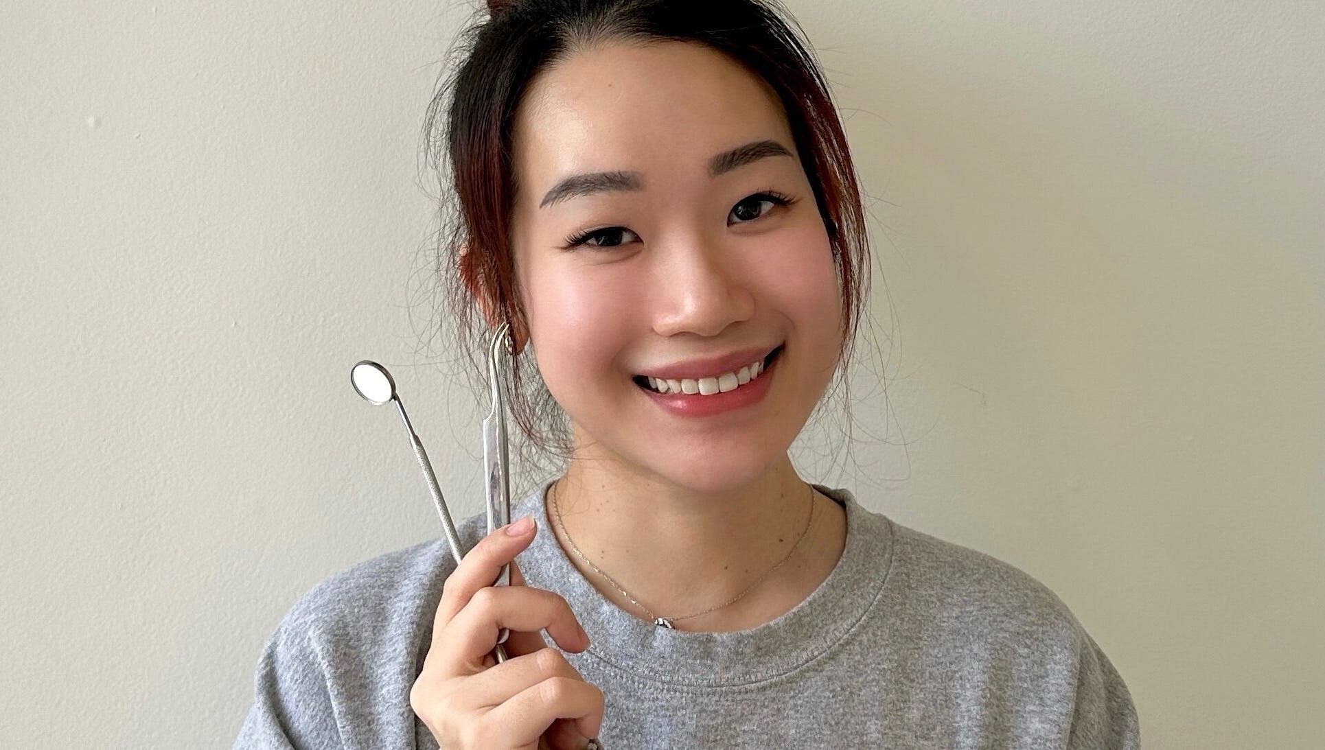 Smiling person holding beauty tools at Blinkwzoe, Burnaby, British Columbia, CA.