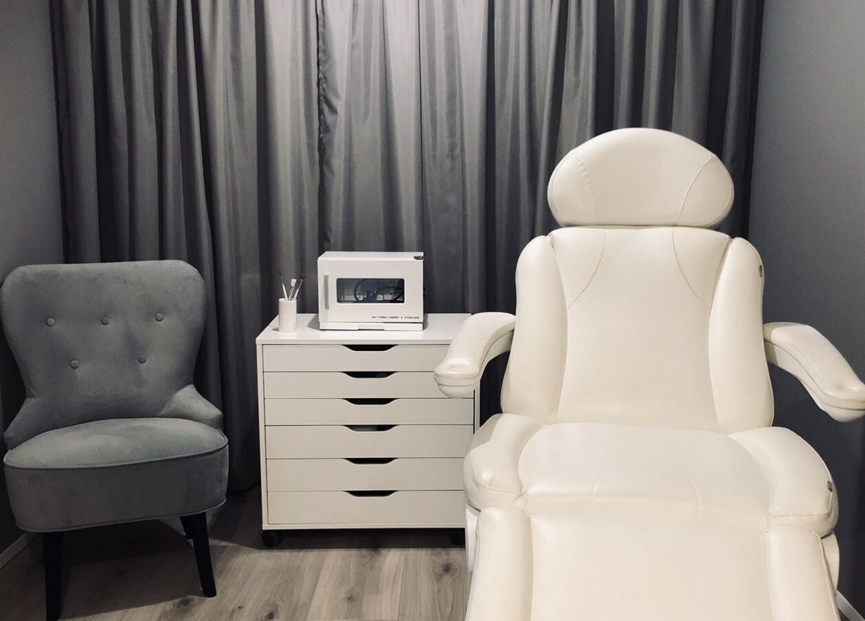 Cozy treatment room at Snyrtihofið, Stykkishólmur, IS, featuring a plush chair and white recliner.