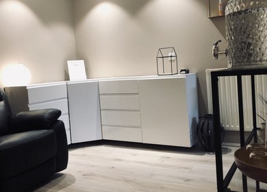 Relaxing lounge area at Snyrtihofið in Stykkishólmur, IS, featuring a plush leather chair and modern decor.