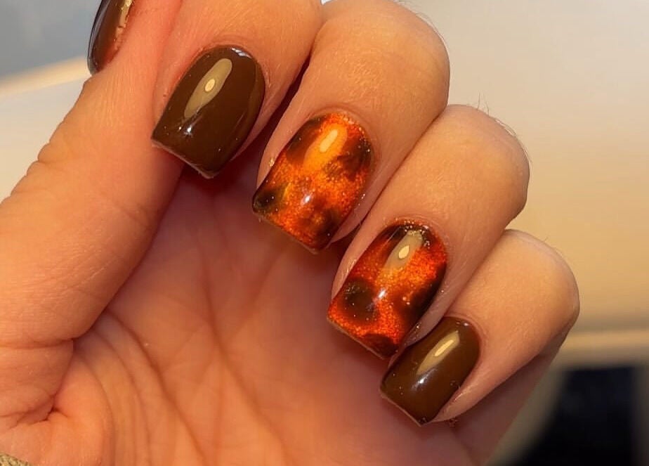 Stylish autumn-themed manicure at Beauty By Katie Davies, Neath, Wales, GB, featuring glossy and reflective designs.