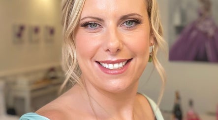 Smiling woman at Dan Campbell Makeup, Glasgow, Scotland, GB, showcasing elegant beauty in a serene setting.