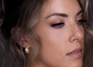 Close-up of elegant makeup by Dan Campbell Makeup, Glasgow, Scotland, GB. Soft eyeshadow and shimmering earrings.