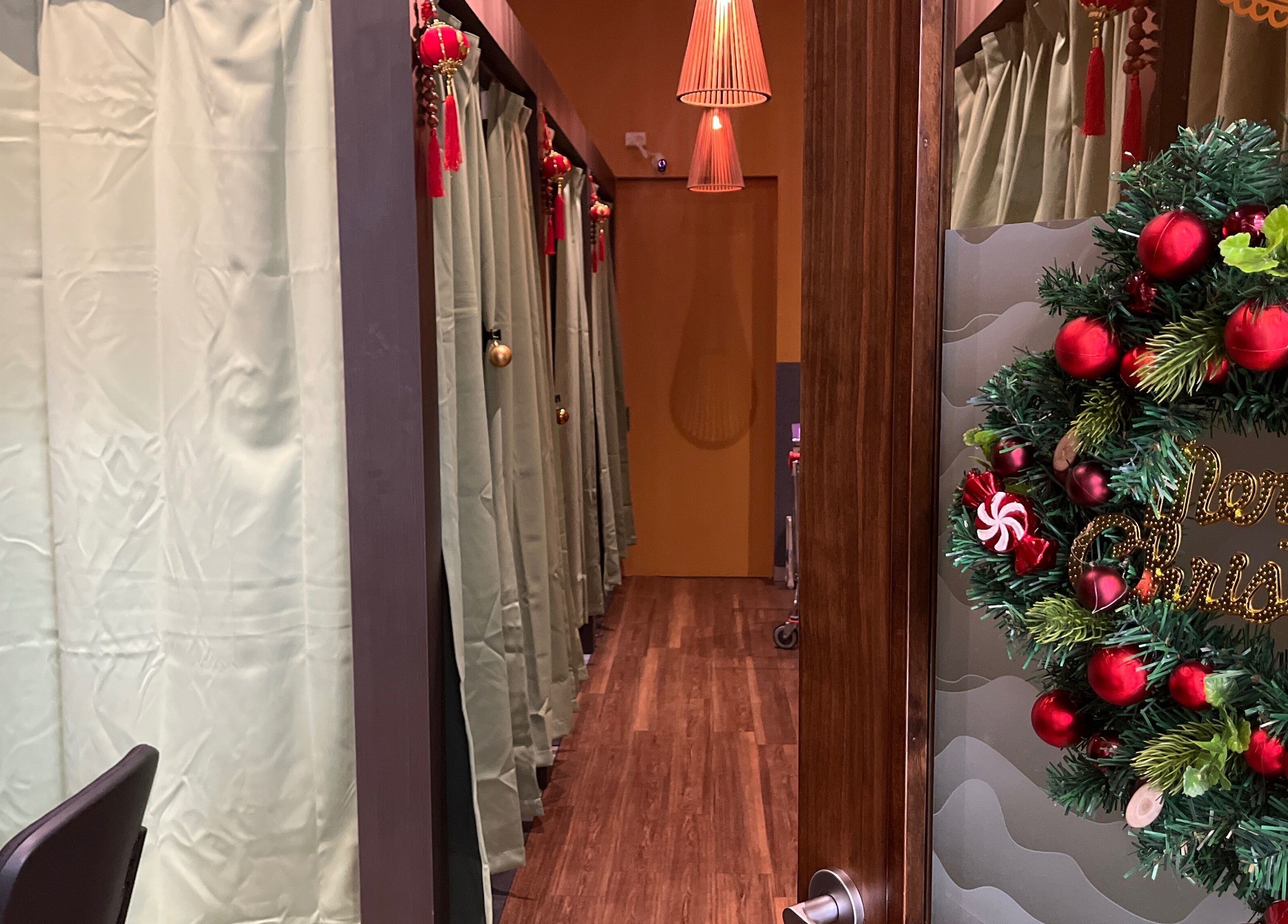 GT Massage in Joondalup decorated for Christmas, featuring a wreath and elegant massage room entrances.