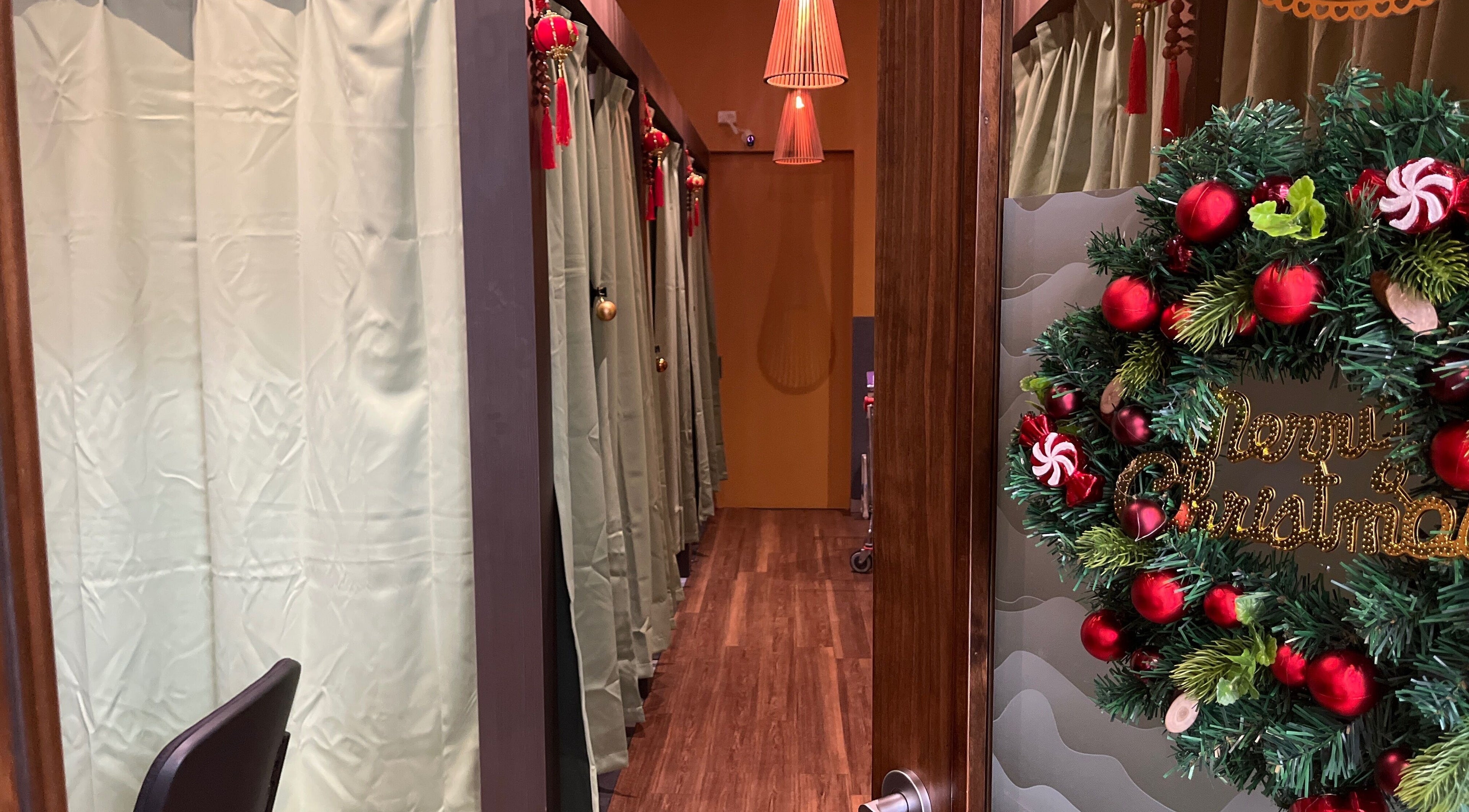 GT Massage in Joondalup decorated for Christmas, featuring a wreath and elegant massage room entrances.