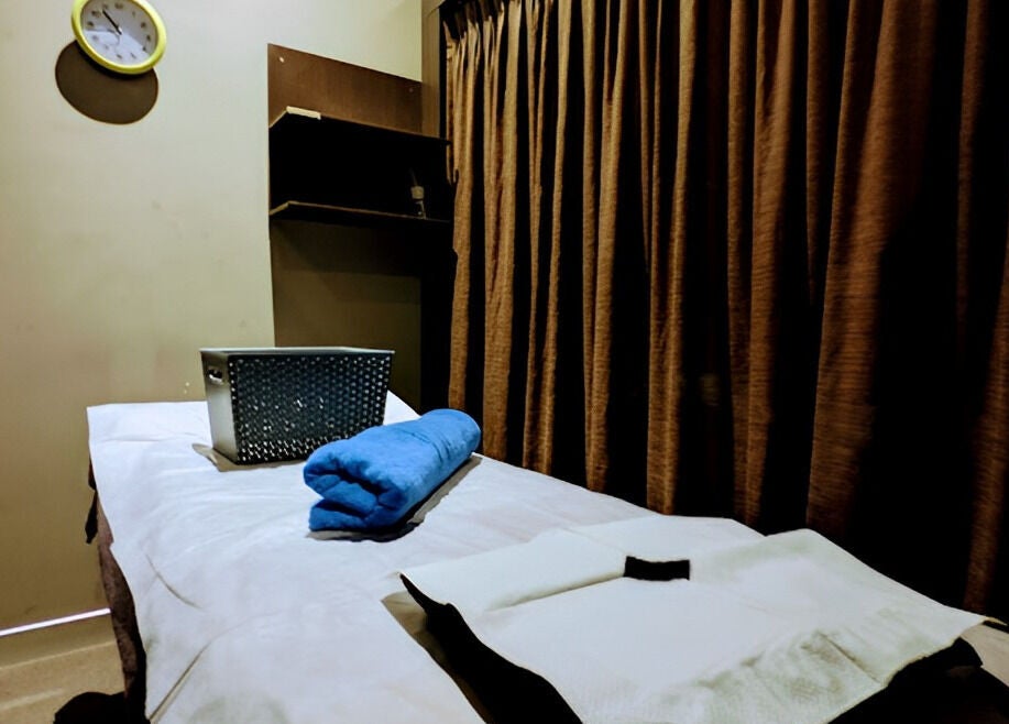 Relaxing massage room at GT Massage in Joondalup, Western Australia, AU with ambient lighting and cozy bed.