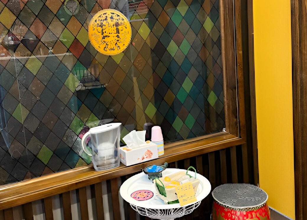 Cozy waiting area at GT Massage, Joondalup, Western Australia, with vibrant stained glass and cozy seating.