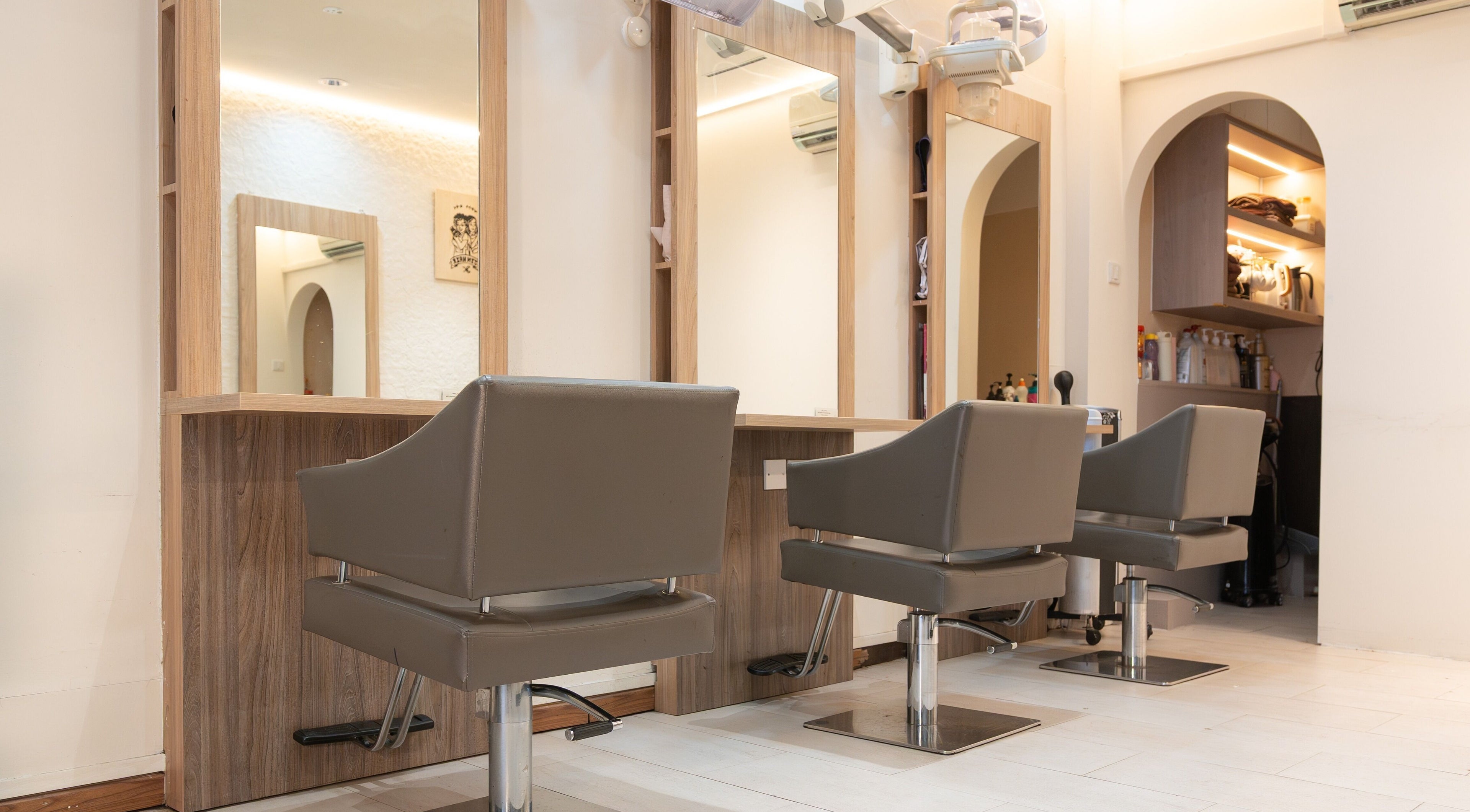 Sleek chairs and mirrors at Jin Hair, Singapore, SG offer a modern salon experience.