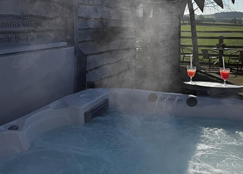 Relaxing hot tub session at Manor Farm Spa - Wellness Lounge, Thorpe Audlin, England, GB with countryside view.