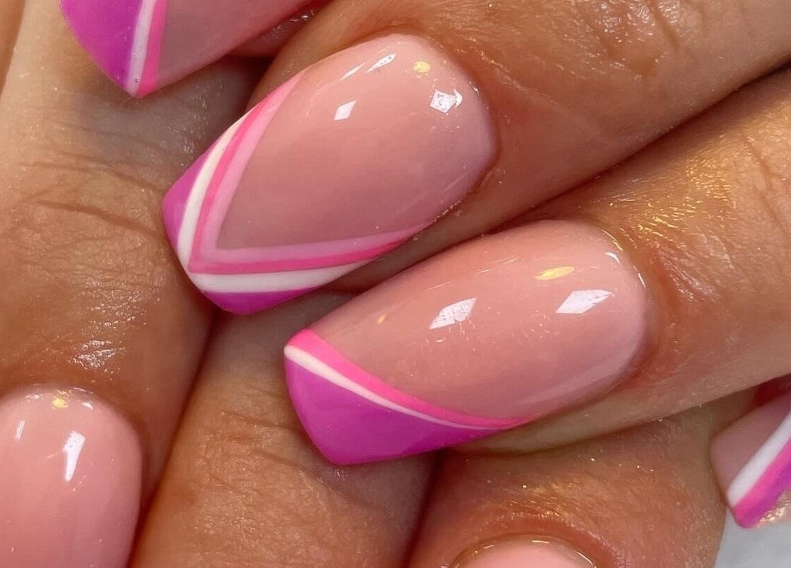 Bright pink manicured nails with geometric design at KC Butterflies, Armthorpe, England, GB.