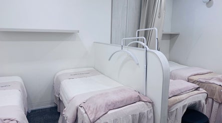 Relaxing treatment beds at Shimmer & Shine at Hougang Rivercourt, Rivercourt, SG for a rejuvenating experience.