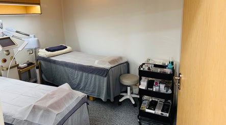 Cozy therapy room at Shimmer & Shine at Hougang Rivercourt, Rivercourt, SG with treatment beds and equipment.