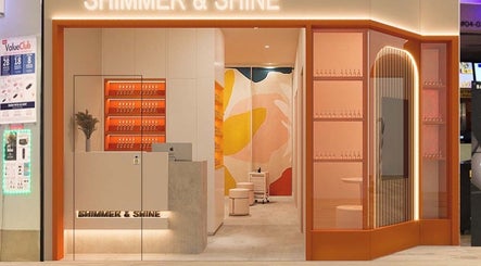 Entrance of Shimmer & Shine at Northpoint, Singapore, featuring modern decor and warm lighting.