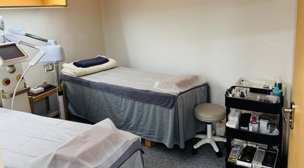 Treatment room with cozy bed at Shimmer & Shine at Hougang Rivercourt, Rivercourt, SG.