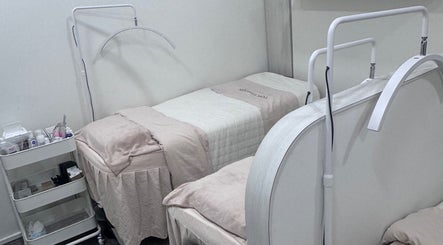 Relaxing treatment room at Shimmer and Shine, Kovan Heartland Mall, Kovan, SG with cozy beds and equipment.