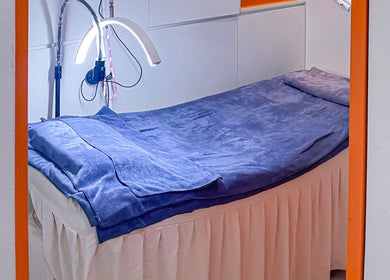 Cozy treatment room at Shimmer & Shine at Northpoint, Singapore, Singapore, SG with plush bed and soothing lights.