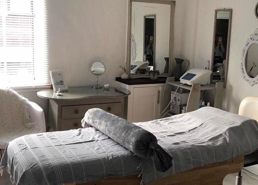 Tranquil beauty room at Enhanced, Worcester, England, GB, featuring a cozy treatment bed and elegant decor.