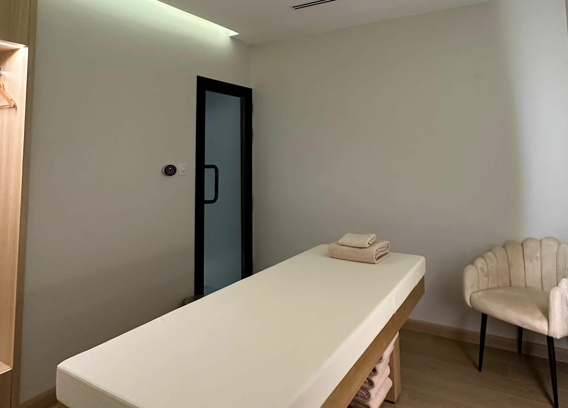 Relaxing therapy room at Regina Spa Dubai (First Spa), Dubai, AE, featuring a massage table and soft lighting.