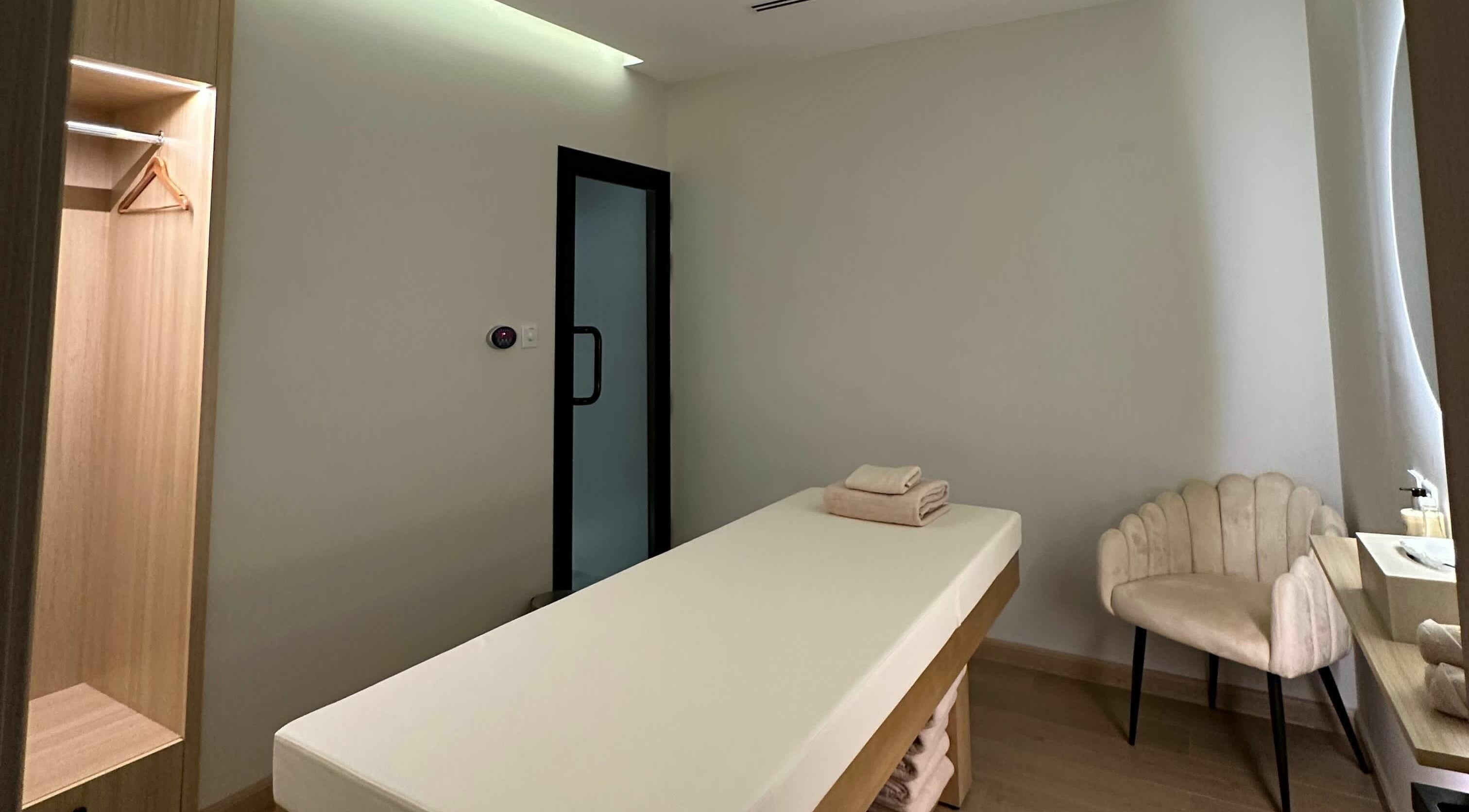 Relaxing therapy room at Regina Spa Dubai (First Spa), Dubai, AE, featuring a massage table and soft lighting.