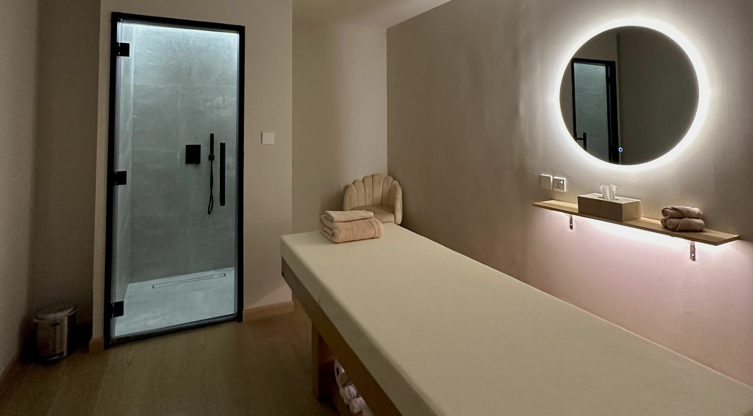 Serene massage room at Regina Spa Dubai (First Spa), Dubai, AE, featuring a sleek modern design.