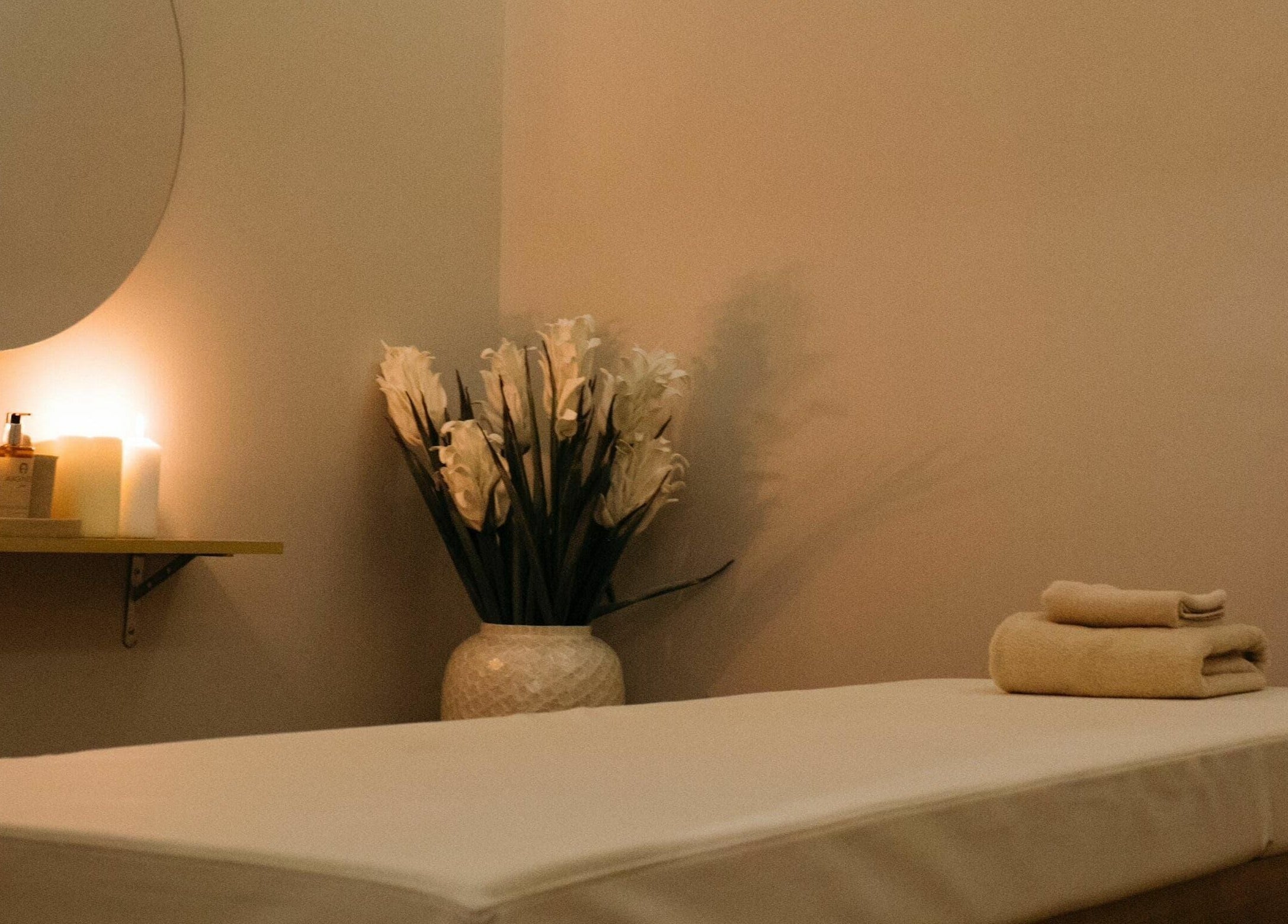 Relaxing massage room at Regina Spa Dubai (First Spa), Dubai, Dubai, AE with calming candles.