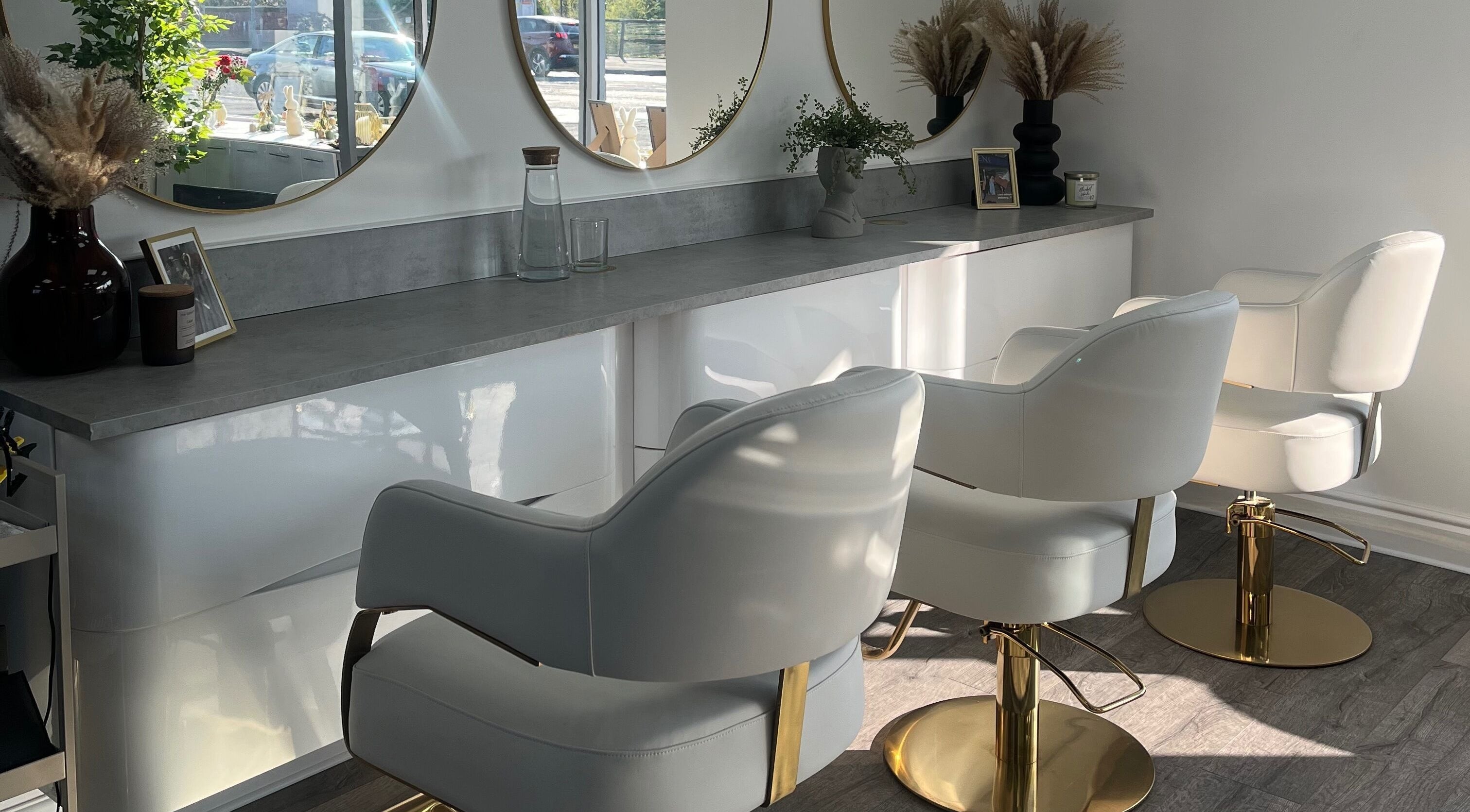 Modern salon chairs at Se.rene Hair & Beauty, Chadderton, England, GB with luxurious decor and mirrors.
